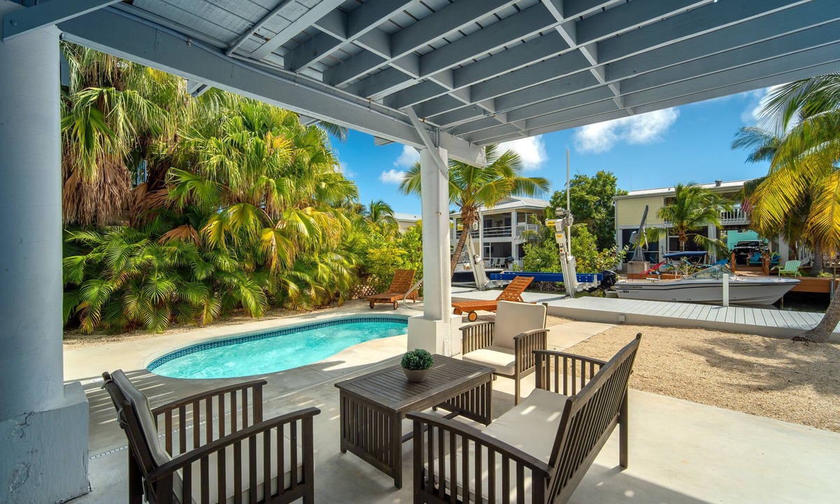 Breezeswept Beach Estates House | Cayman Retreat | Cozy coastal pool home with boating on Ramrod Key