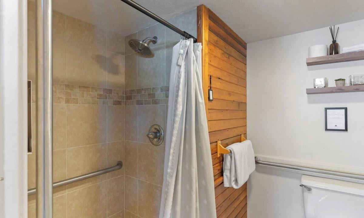 Clark Cabin | Comfortable private queen room in the True North Adventure Lodge. Includes a queen bed, private ensuite bathroom, and access to shared amenities like the kitchen, great room, and hot tub. Great for couples or solo travelers.