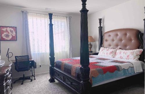 Riverside House | Large master bedroom with Separate bathroom and work desk on the first floor
