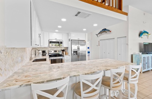 Key Colony Beach House | Waterfront home with dock, filet station, patio, balcony, & Cabana Club access