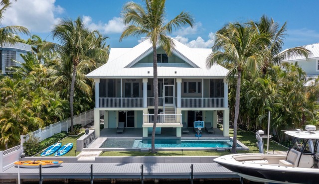 Luxurious tropical water-front Heated pool home with Boat Dock and two master .